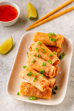 Fried spring rolls served with lime and sauce