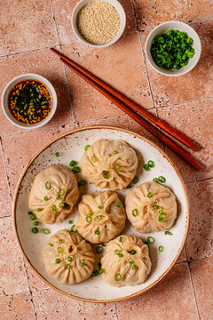 Dumplings served with green onions on a plate
