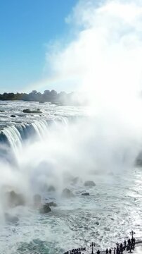 Majestic Waterfall: A breathtaking view of powerful cascades surrounded by mist and vibrant greenery, showcasing the untouched beauty of nature's grandeur and tranquility.
