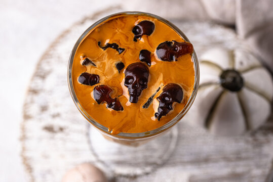 Halloween drink coffee latte with ice in shape of skull
