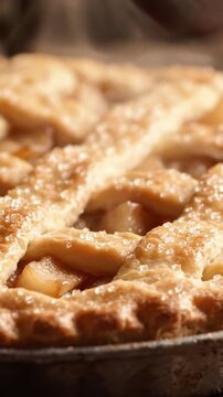 Deliciously Golden Brown Apple Pie: A Close-Up View of Flaky Crust and Sweet Juicy Filling with a Glimmering Sugar Finish that Tempts Every Dessert Lover.