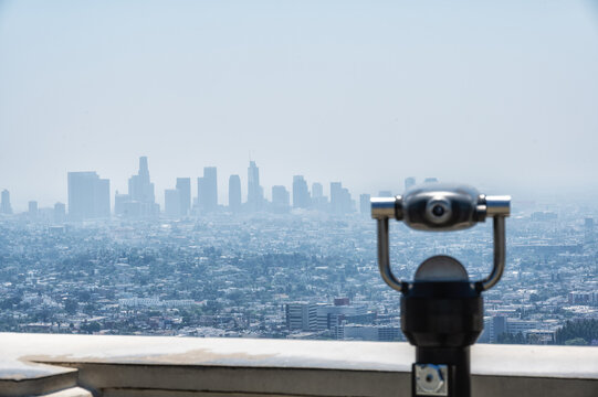 Panoramic view of Downtown Los Angeles skyline from Griffith Observatory with public viewing telescope in California, USA