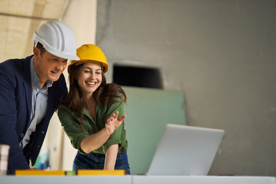 Project managers working on laptop at construction site