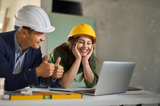 Two real estate developers working on a computer at construction site