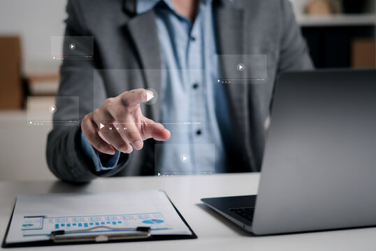 Businessman touching a virtual screen with his hands for online streaming watch videos on the internet online webinars internet education e-learning concept