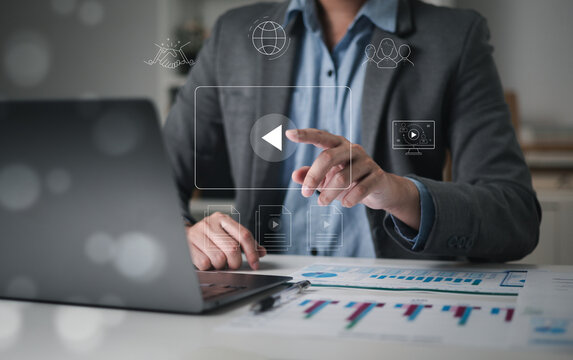 Businessman touching a virtual screen with his hands for online streaming watch videos on the internet online webinars internet education e-learning concept
