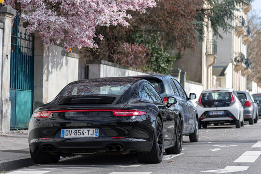 Nancy, France - March 30th 2019 : View on a black Porsche 991 Carrera 4 GTS parked on a street.
