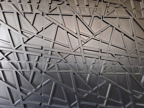 Metallic geometric patterns dominate the surface