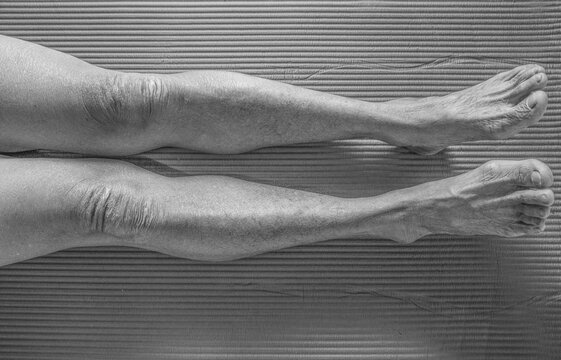 Close up of man's legs on gray wall background, vintage tone