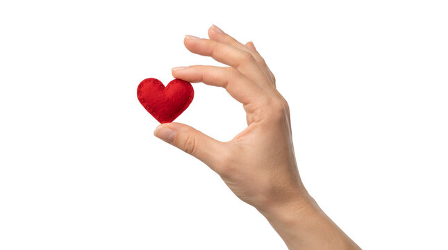 A hand holding a small red heart for the concept of love and care.