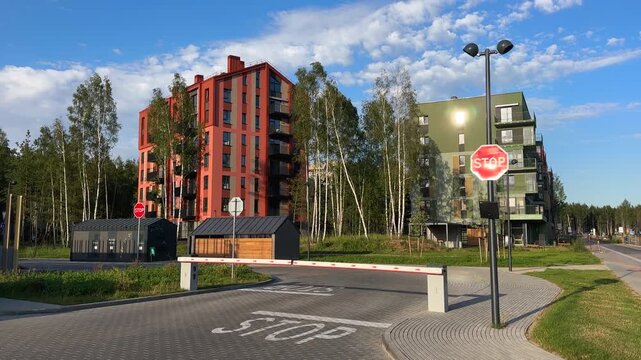 Automatic car barrier in Private urbanization residential area. Car barrier with stop sign in Condominium. Open barrier at exit from residential. Barrier for entry, exit to parking lot for residents c