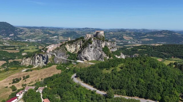 Cinematic aerial shot of the impregnable rock outcrop fortress of San Leo in the Montefeltro region