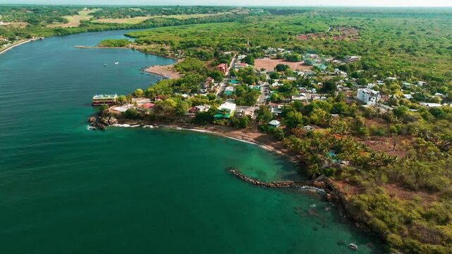 Aerial view of Boca Chavon showing the river mouth, lush vegetation, and coastal landscape in La Romana, La Romana, Dominican Republic.