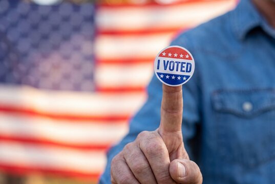 Man holding i voted today sticker with american flag draped over his shoulders outdoors with close camera national holding circular, 8k