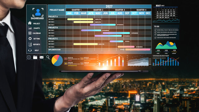 Business Professional Analyzing Project Management Dashboard on Laptop During Night Cityscape with Graphs and Charts for 2027 Fluxor.
