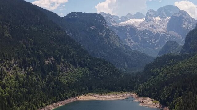 Aerial View Gosau Alpine Lake Beneath Dachstein Mountains

Drone footage reveals tranquil mountain waters framed by forests and dramatic peaks, Gosau, Austria, 11 August 2026.
