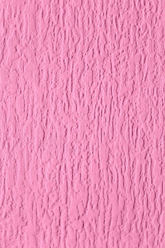 Close-up of pink painted embossed anaglypta wallpaper wallcovering background. Retro interior design wallpaper.