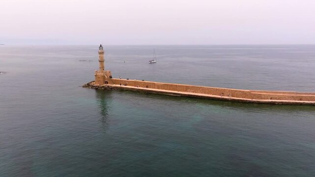  View of Chania with the amazing lighthouse, mosque, venetian shipyards, Crete, Greece.Waves crashing on lighthouse, Beautiful Greece and best scenic places - panorama