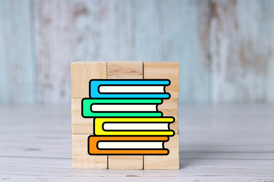 Concepts of studying, back-to-school, learning, note-taking, office work, and books on wooden cubes.