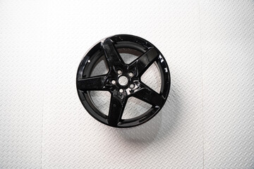 Black alloy car wheel isolated on white background
