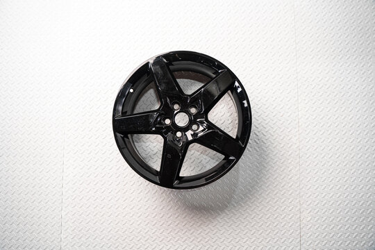 Black alloy car wheel isolated on white background