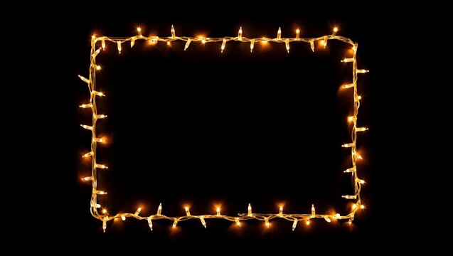 Glowing string lights frame on black background for festive holiday designs.