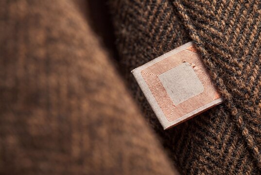 Woven RFID Tag Sewn Into Tweed Garment Fabric Macro