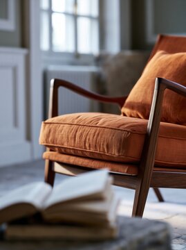 Orange upholstered armchair with open book in cozy reading interior