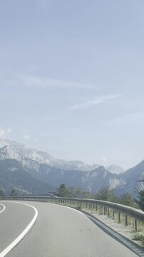 Driving along a mountain road near Lake Garda with cyclists in the Italian Alps