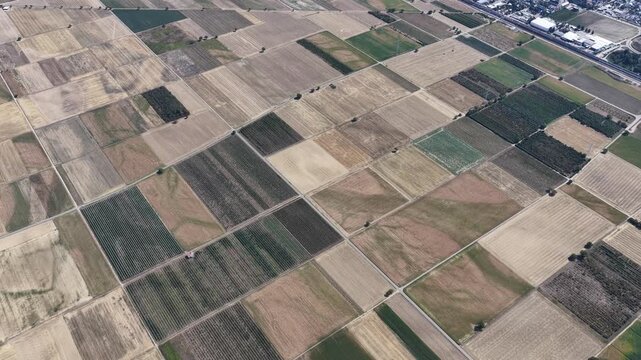 Aerial view of agricultural fields with diverse crop patterns and textures in Hombourg, Grand Est, France.