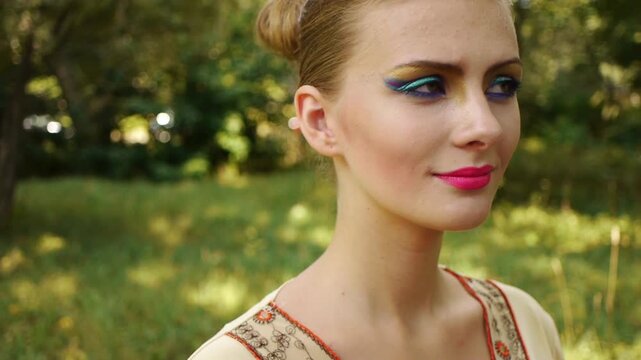 young woman colouring her eyelids