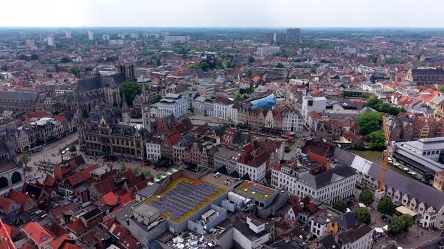 Aerial view video clip of Ghent historic center, St Nicholas Church, Post Plaza, Korenmarkt square, and city rooftops in East Flanders, Belgium