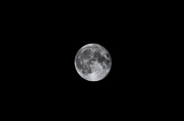 Full moon glowing in pitch black night sky with copy space © Jotaiglesias17