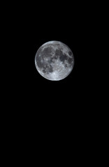 Full moon glowing in pitch black night sky with large copy space below © Jotaiglesias17