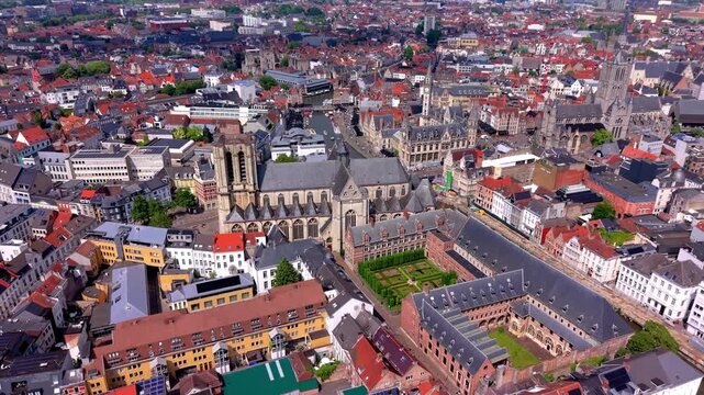 Aerial view video clip of Saint Michael Church, Saint Michael Bridge, Leie canal, courtyard garden, historic guild houses, and cityscape skyline in Ghent, East Flanders, Belgium
