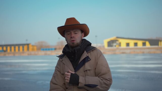 man in cowboy clothes outdoors dancing emotional dance
