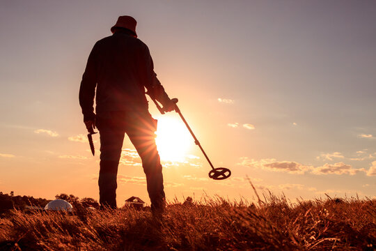 Evening Detectorist Silhouette with Digging Knife and Metal Detector
