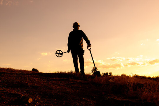 Sunset Treasure Hunter with Shovel and Metal Detector, Panama Hat