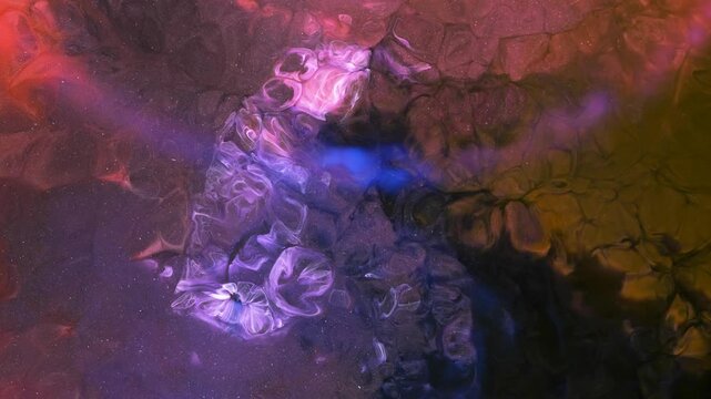 Mixing different colored alcohol inks in a close-up view