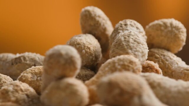 Peanuts in Salted Shell Man Cracking and Eating Salty Nuts as a Classic Bar Snack at Cafe