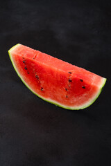 Ripe watermelon on black background © Banu Sevim