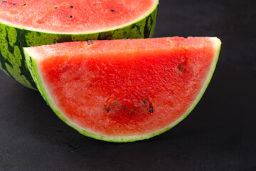 Ripe watermelon on black background © Banu Sevim