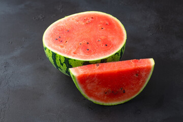 Ripe watermelon on black background © Banu Sevim