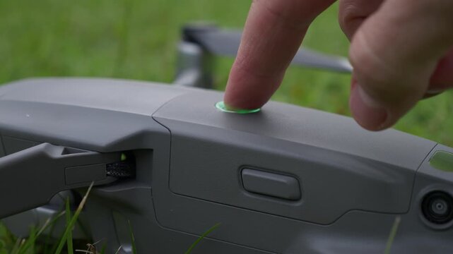 Hand fitting battery into drone compartment