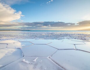 Naklejka premium Aerial view of a snowy coastal village at sunrise.