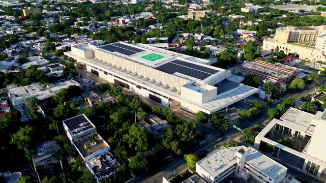 Aerial view of solar panels and a helipad on a modern building rooftop