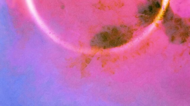 Mixing different colored alcohol inks in a close-up view