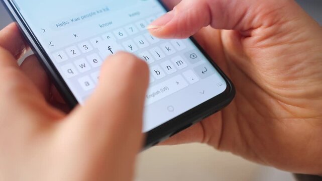 Female hands typing text on smartphone close-up.
