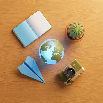 Travel items featuring paper plane earth globe camera and succulent arranged on wooden desktop table.