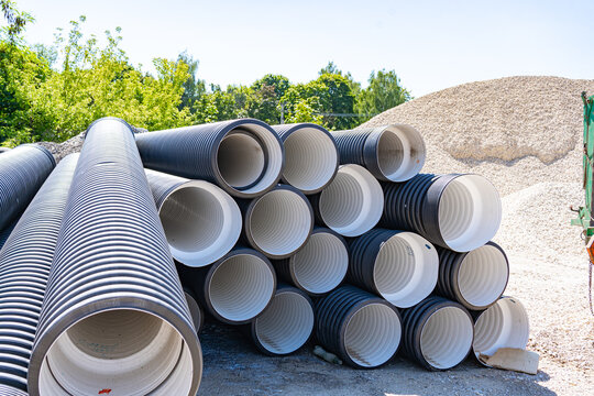 High-density polyethylene corrugated pipes stacked for civil infrastructure and water pipeline projects. Perfect stock image for engineering contractors, sanitation, and plumbing supplies